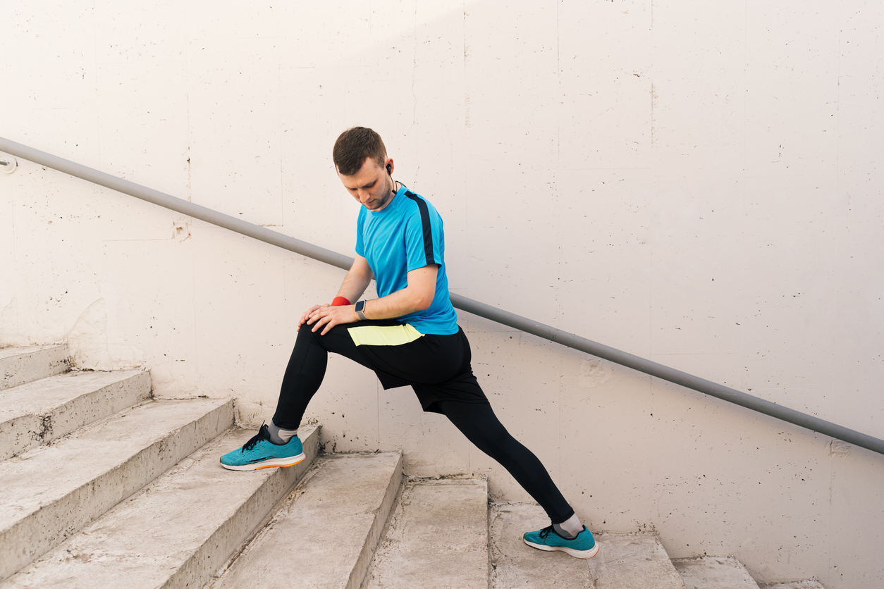 man-stretching-his-glutes-when-walking-up-stairs