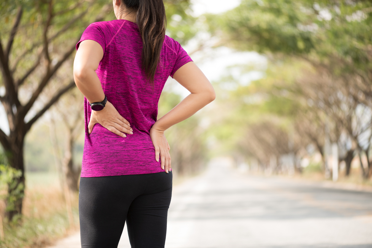 Woman holding back hip flexor pain