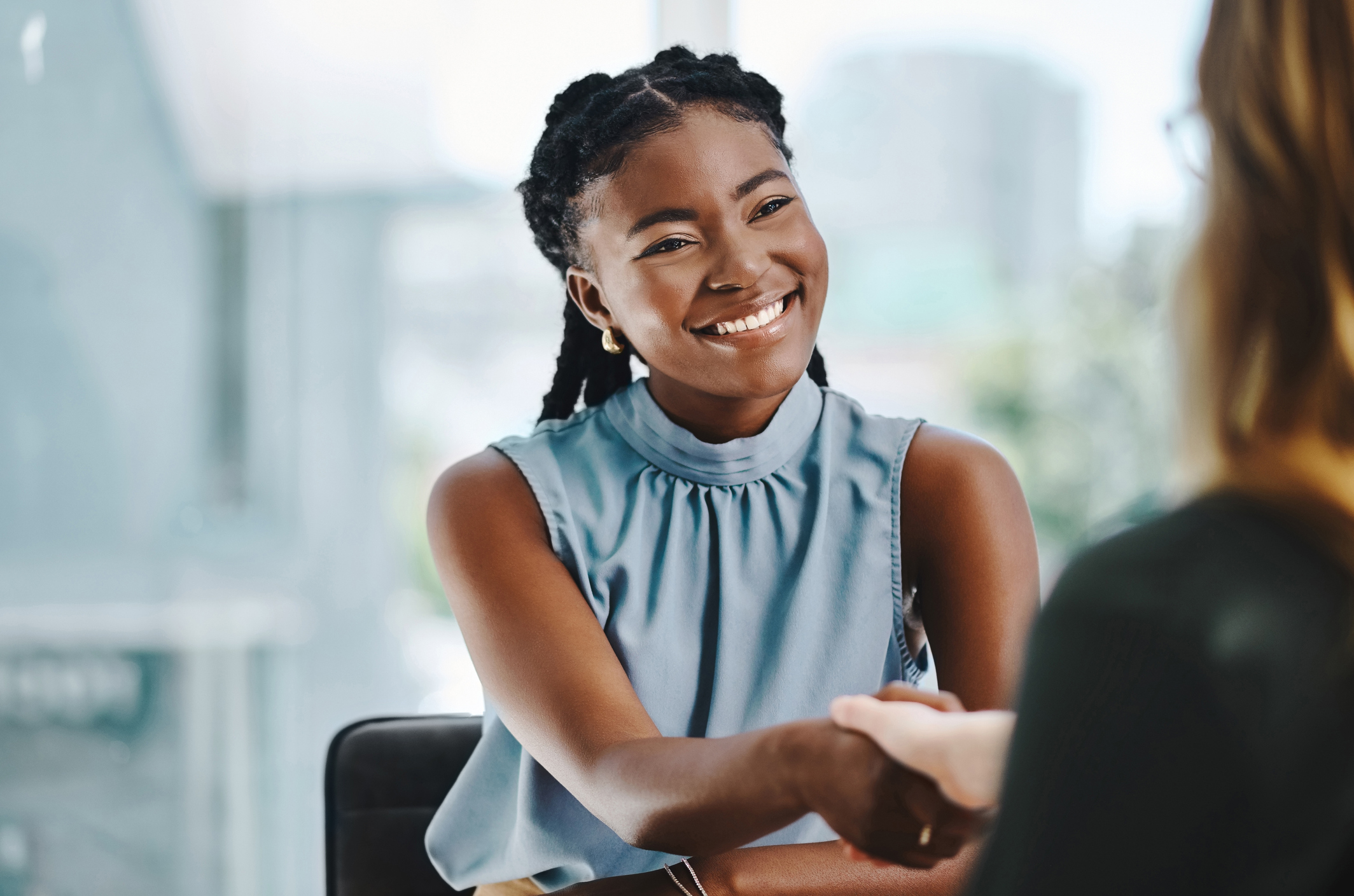 woman-smiling-talking-to-another-woman