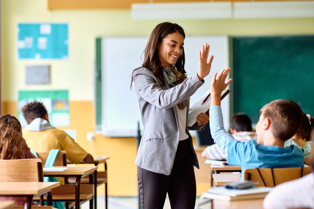 teacher-high-five-student-at-classroom