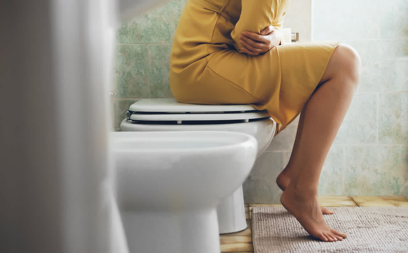 Person sitting on toilet