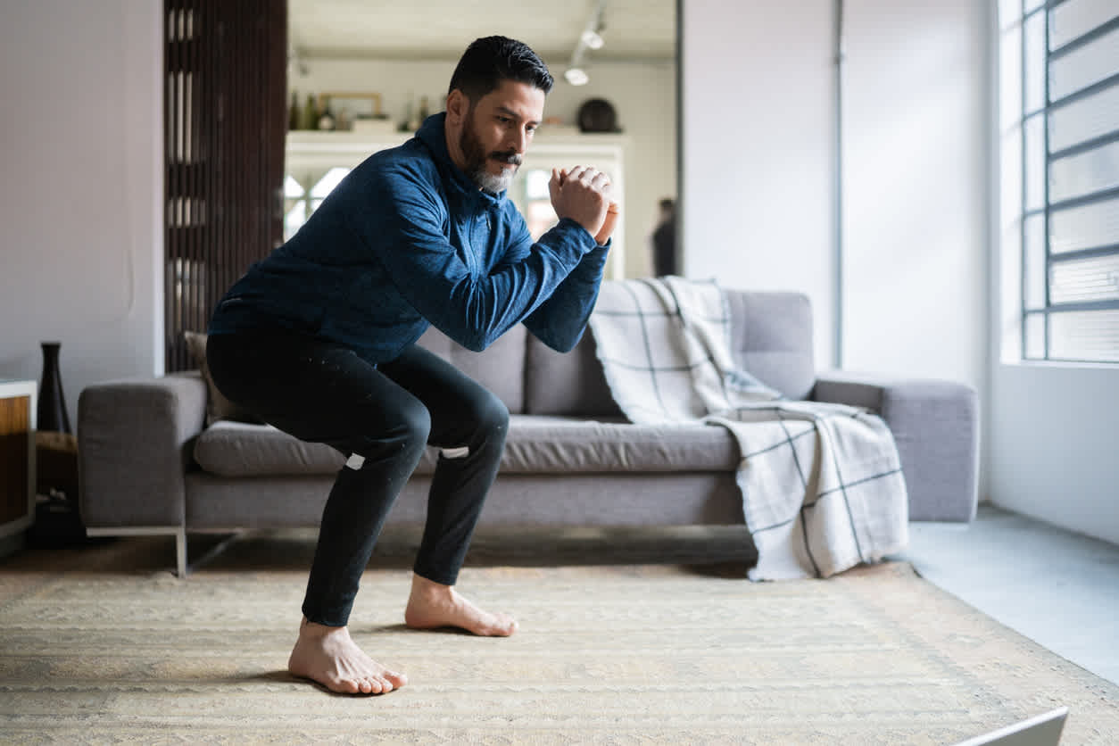 Man-doing-squats-at-home