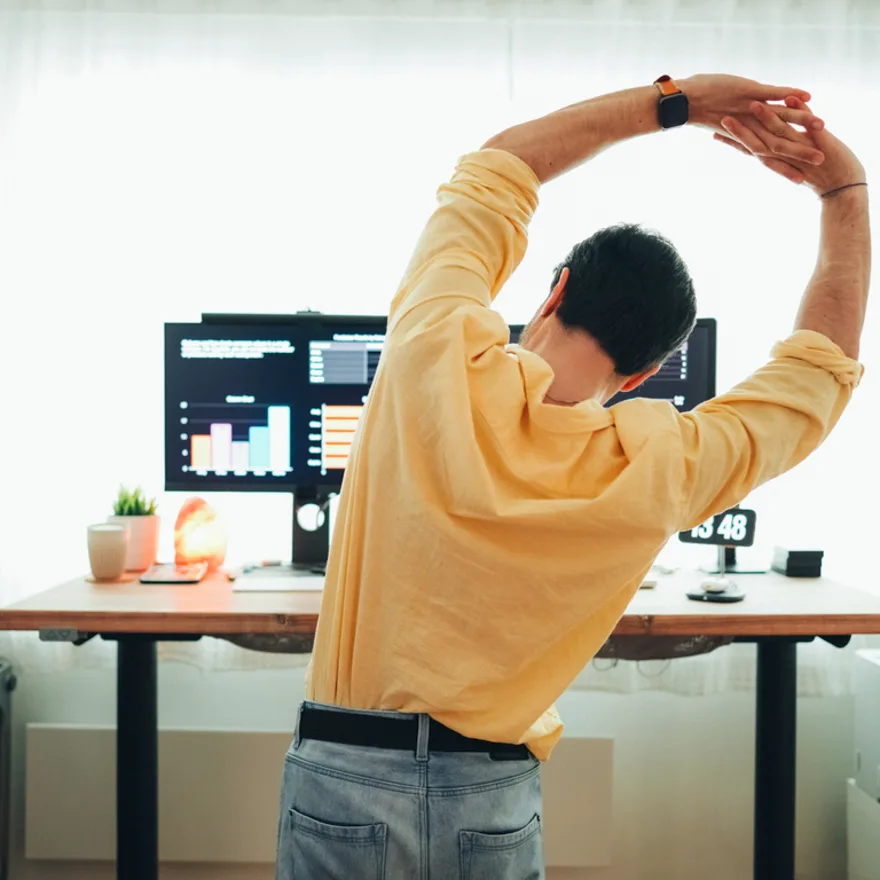 man-stretching-in-front-of-computer
