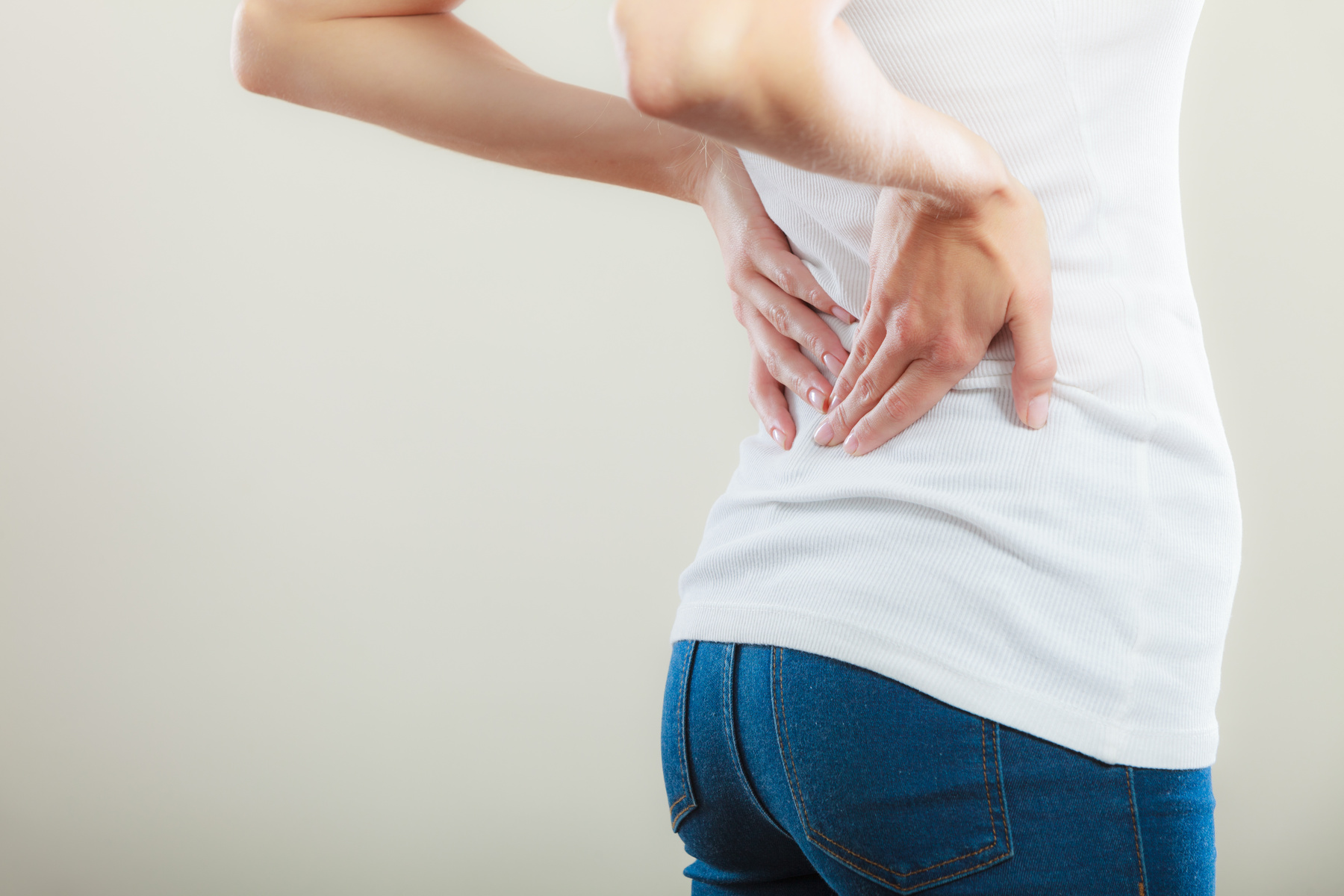 woman touching her back due to back problems