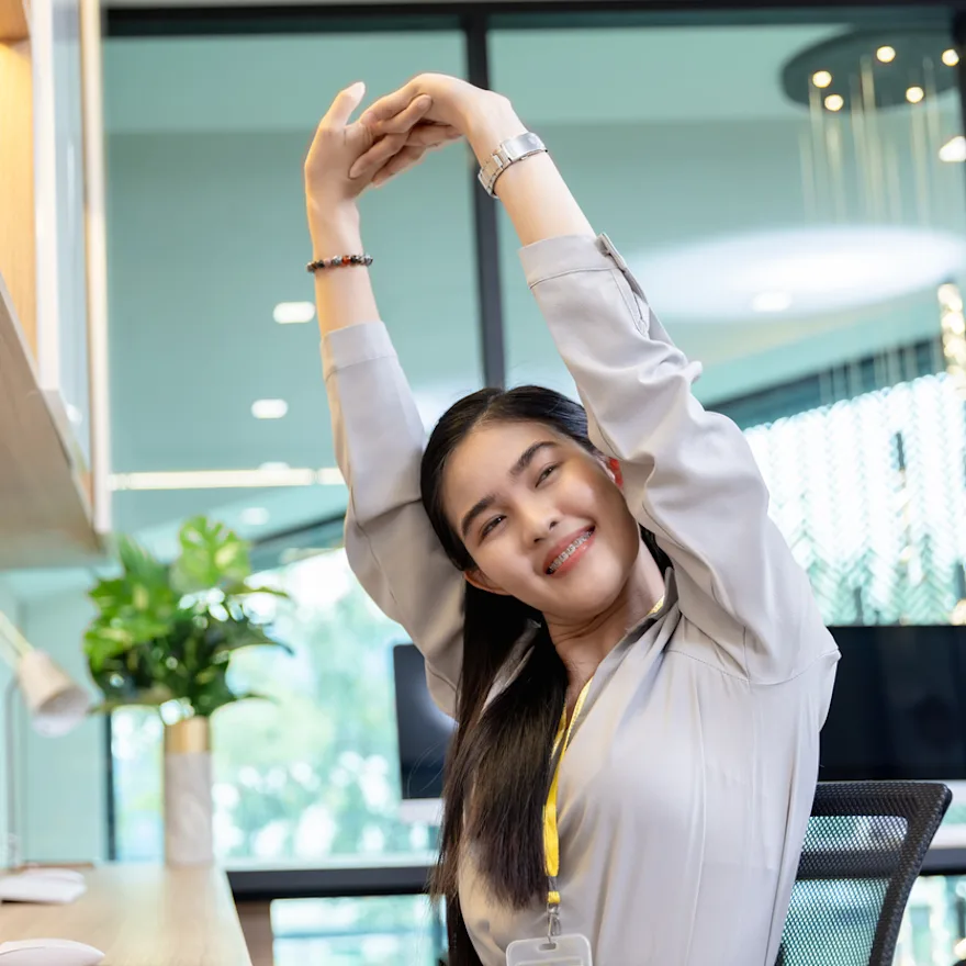 Professional in white business attire performing exercises to improve posture