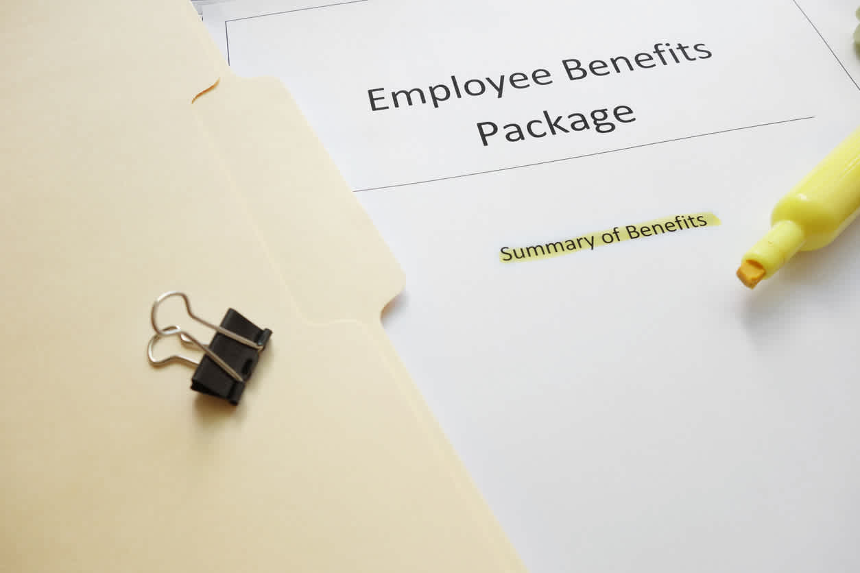 document-that-says-Employee-Benefits-Package-with-highlighter-on-top-of-it