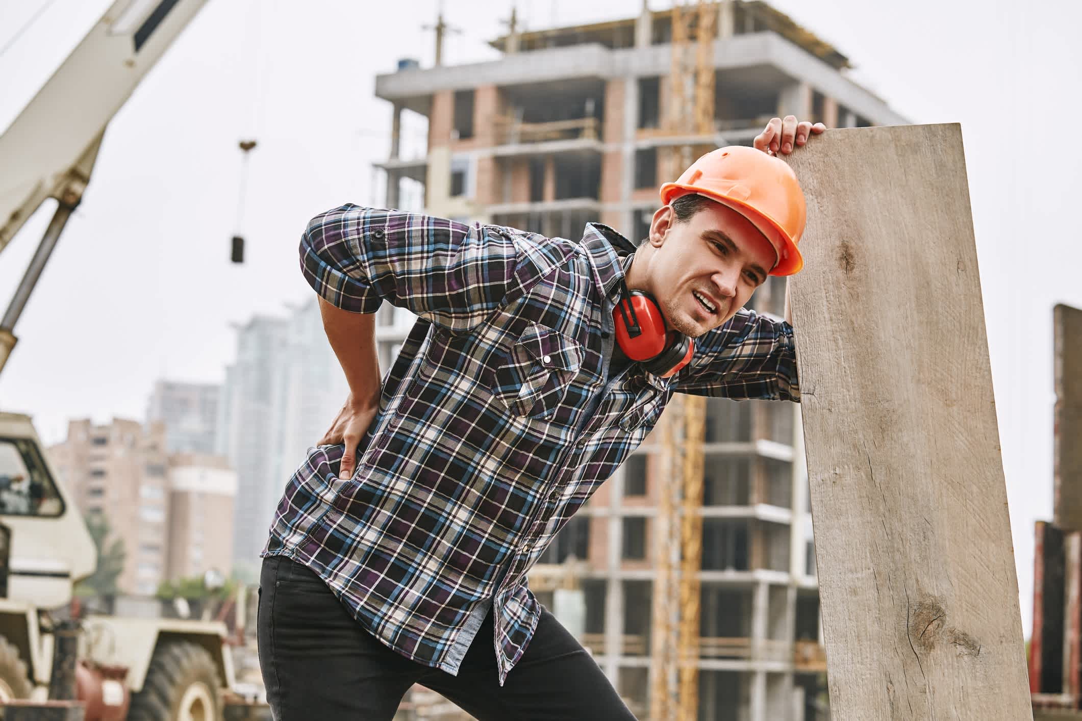 man-holding-his-back-after-injury-in-a-construction-site