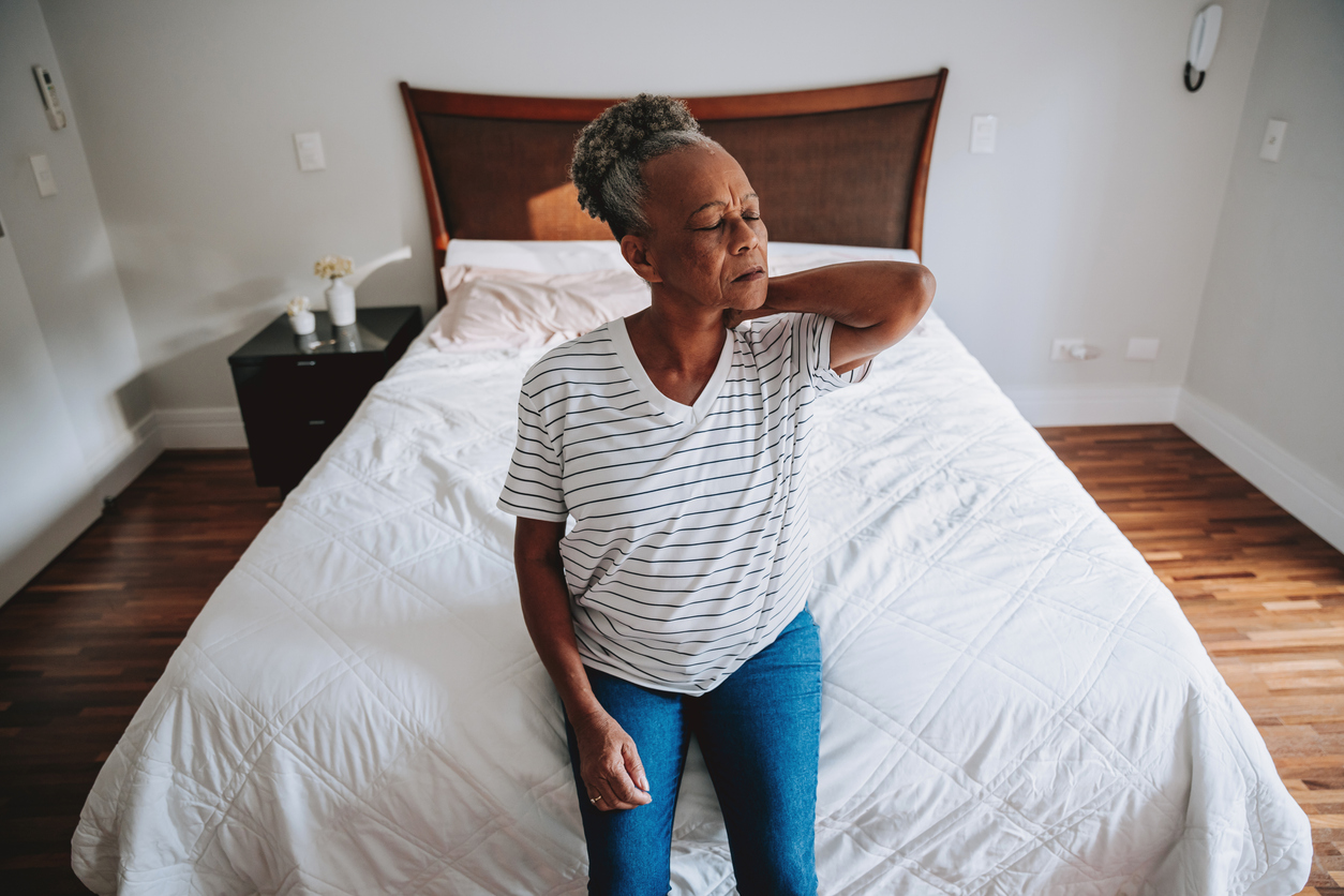 Woman with upper back spasm