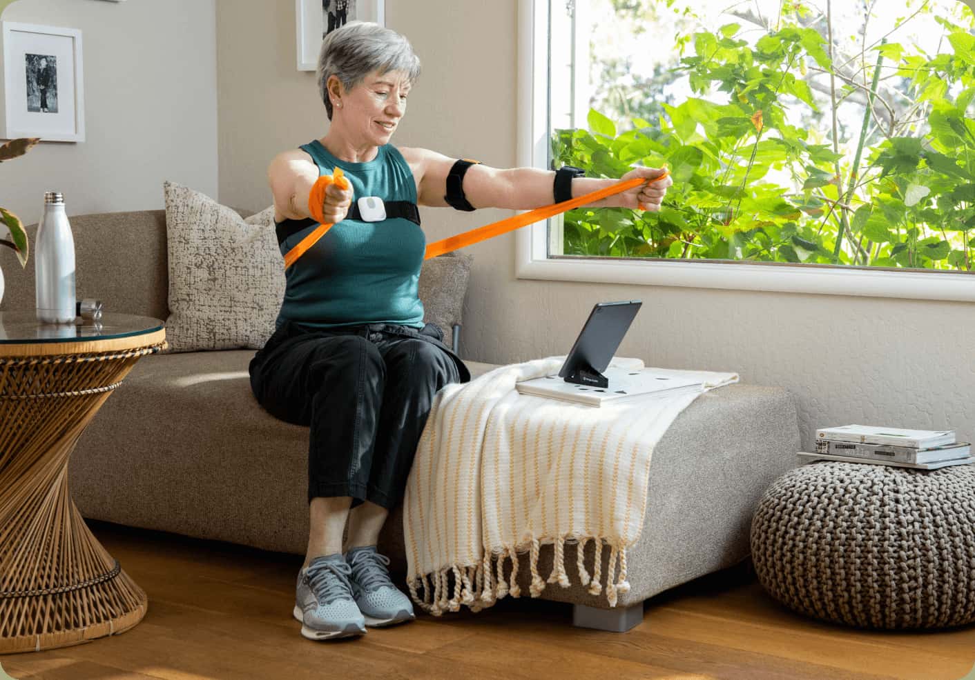 Woman sitting and stretching with resistance bands