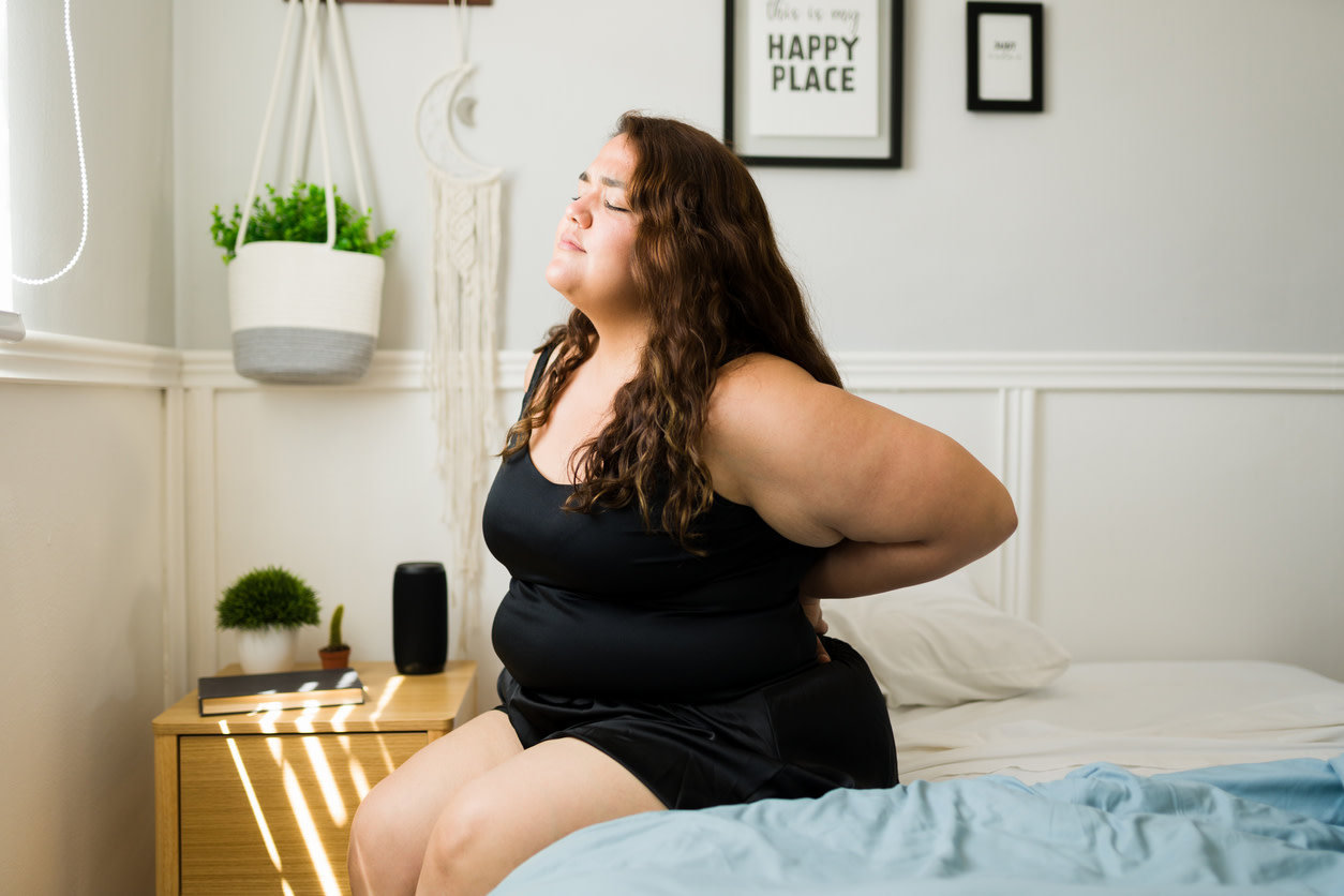 Woman experiencing back pain after c-section.
