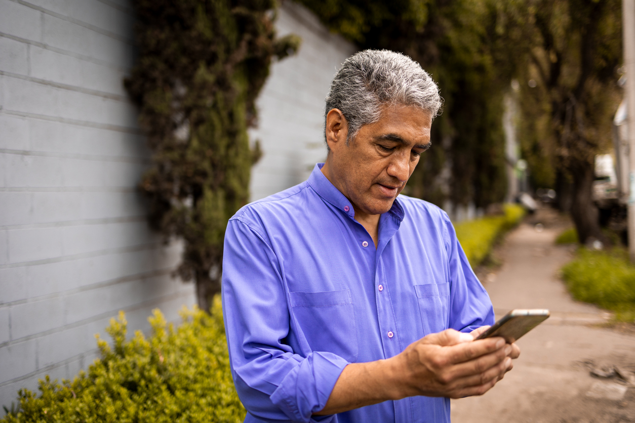 Older-man-with-neck-down-looking-at-his-phone