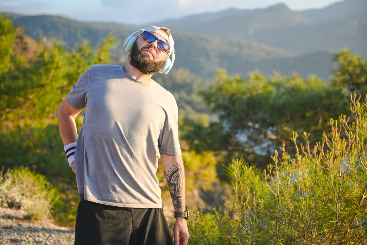 Man-on-hike-outdoors-holding-his-lower-back-in-pain