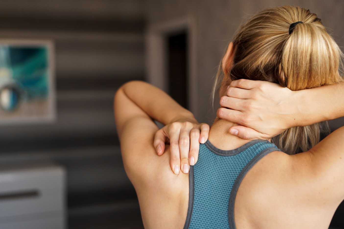 Women holding the back of her neck 