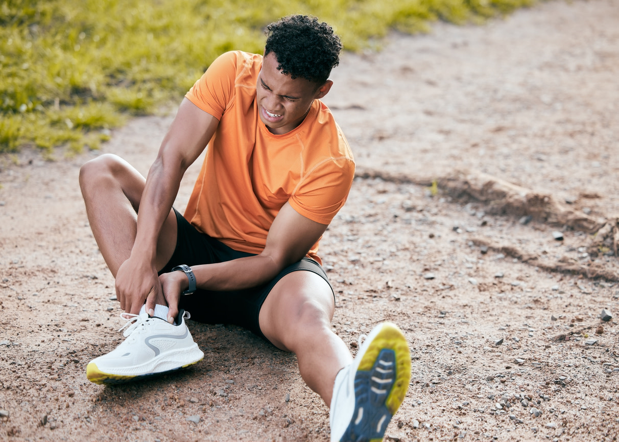 man feeling sudden ankle pain without injury
