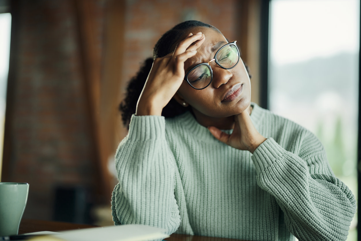woman feeling pinched nerve headache