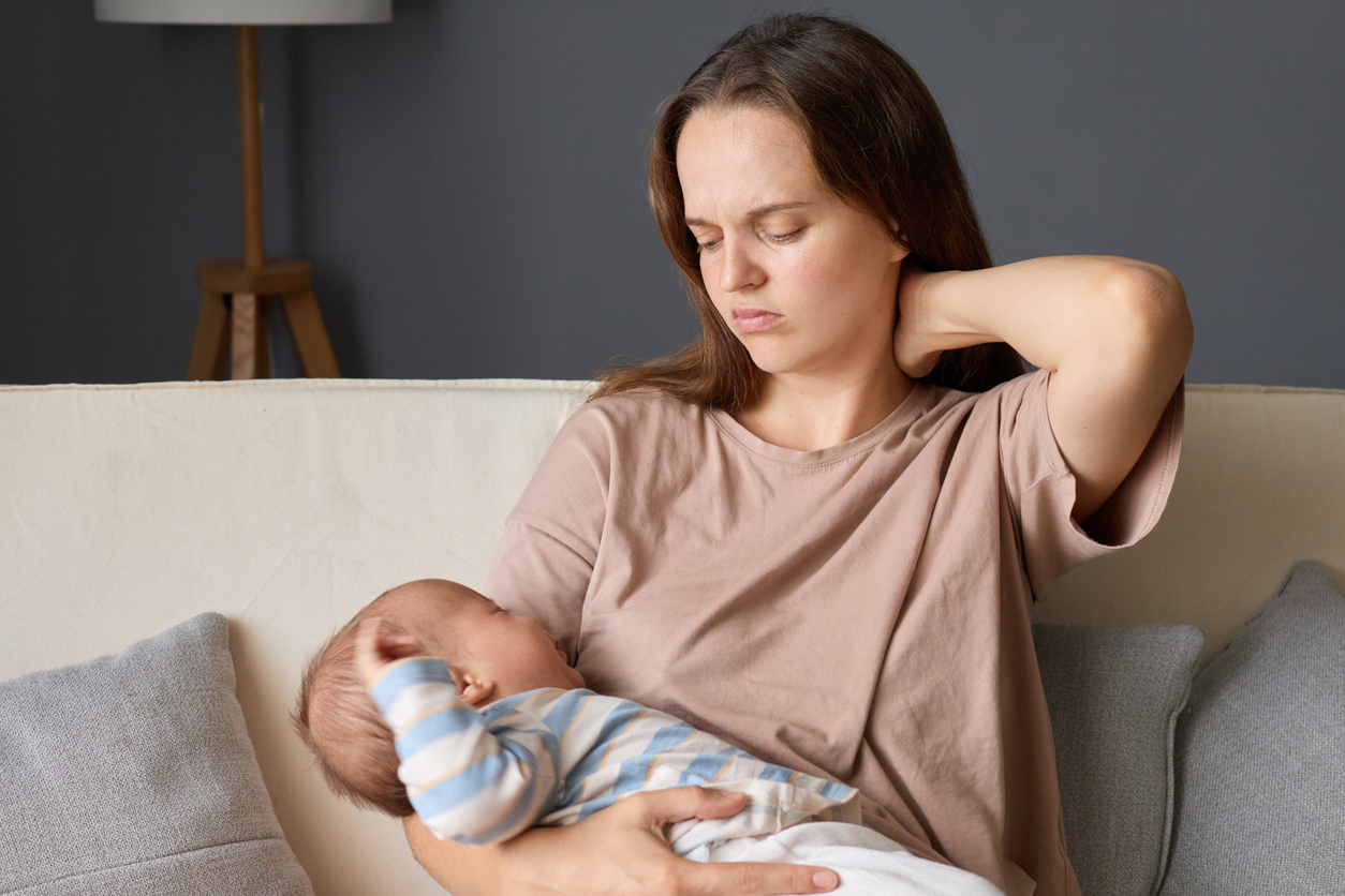 woman feeling postpartum joint pain
