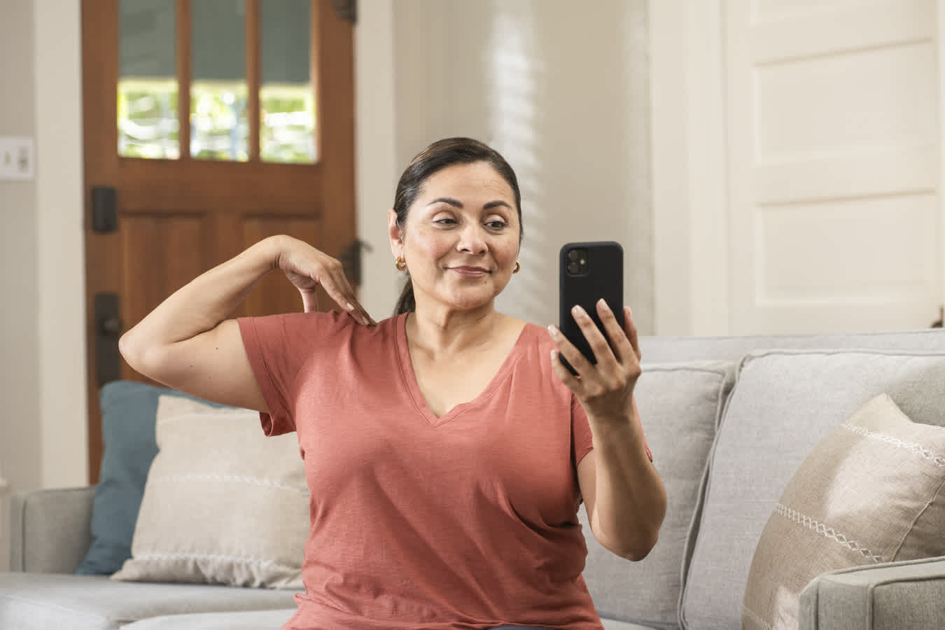 woman doing virtual physical therapy at home