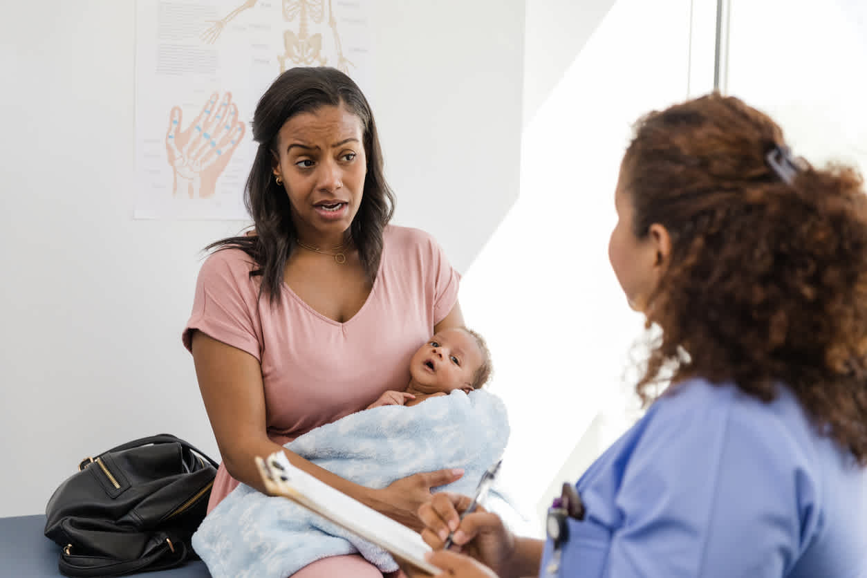 woman-holding-baby-at-medical-office