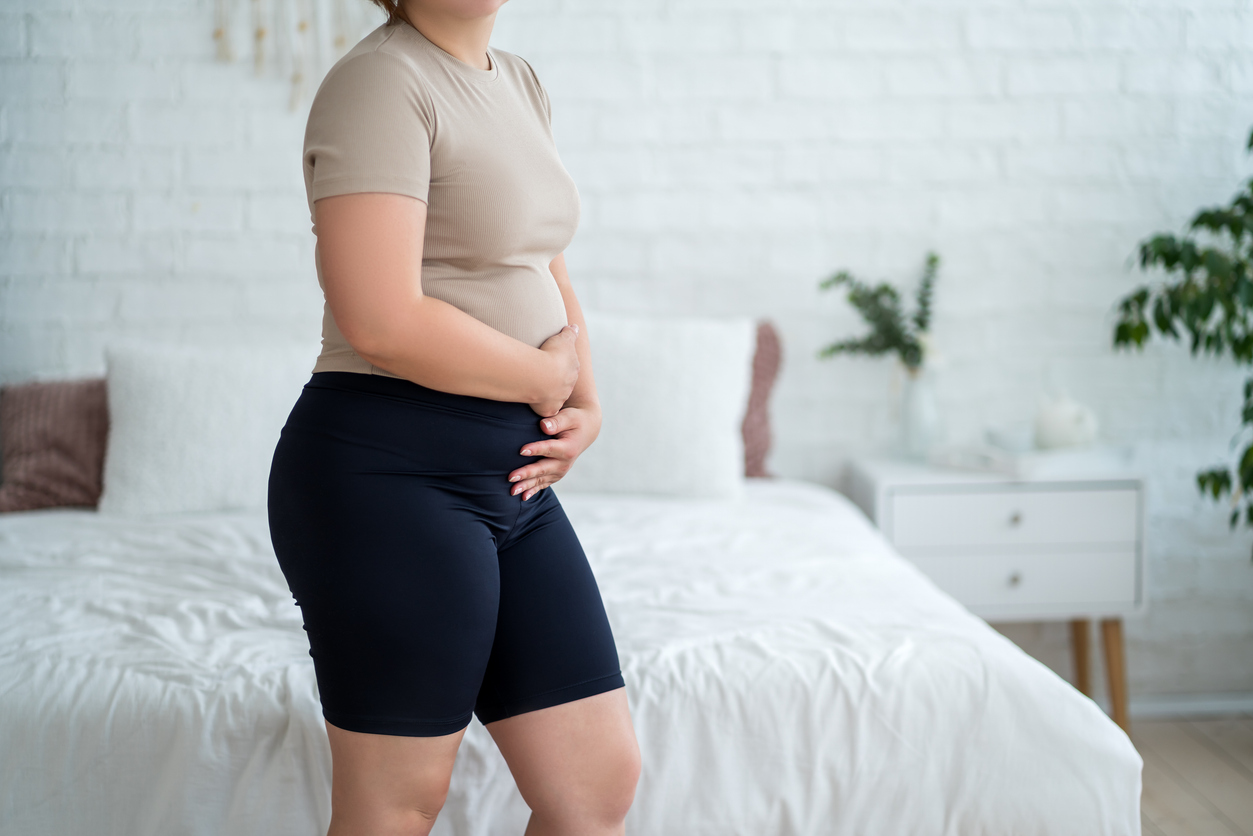 Woman experiencing urinary incontinence during postpartum.
