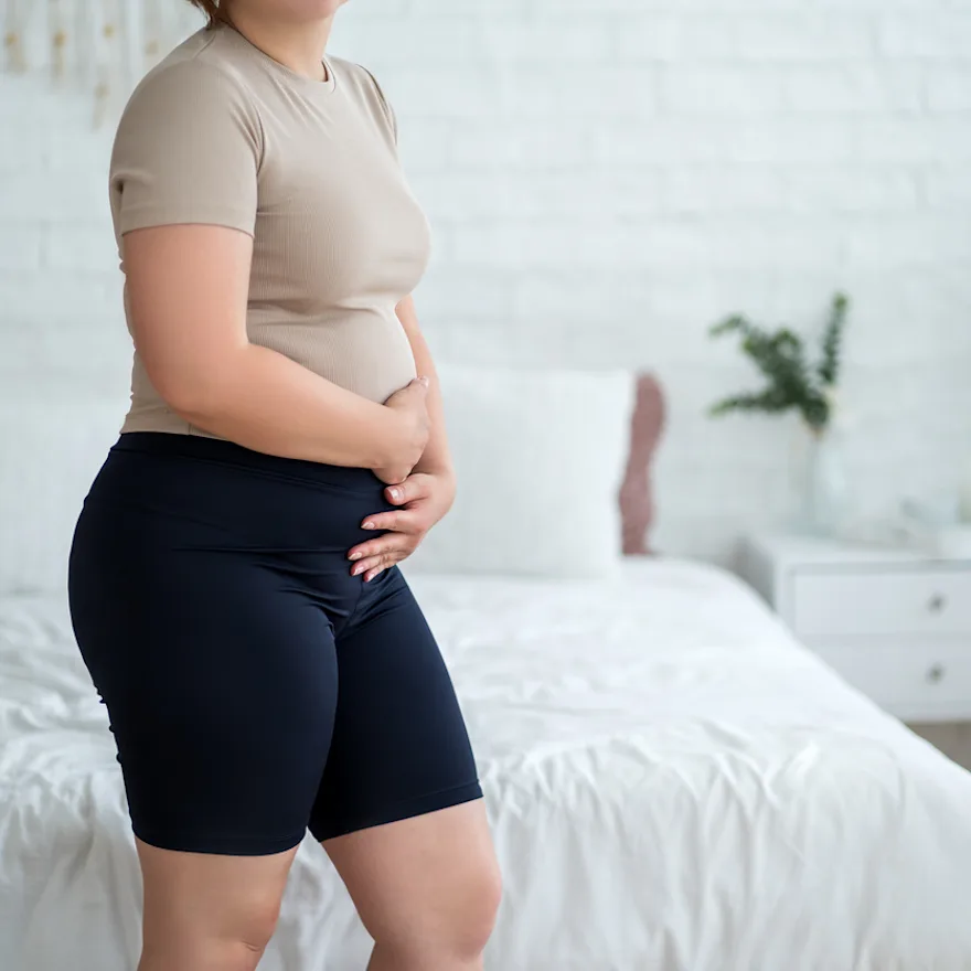 Woman experiencing urinary incontinence during postpartum