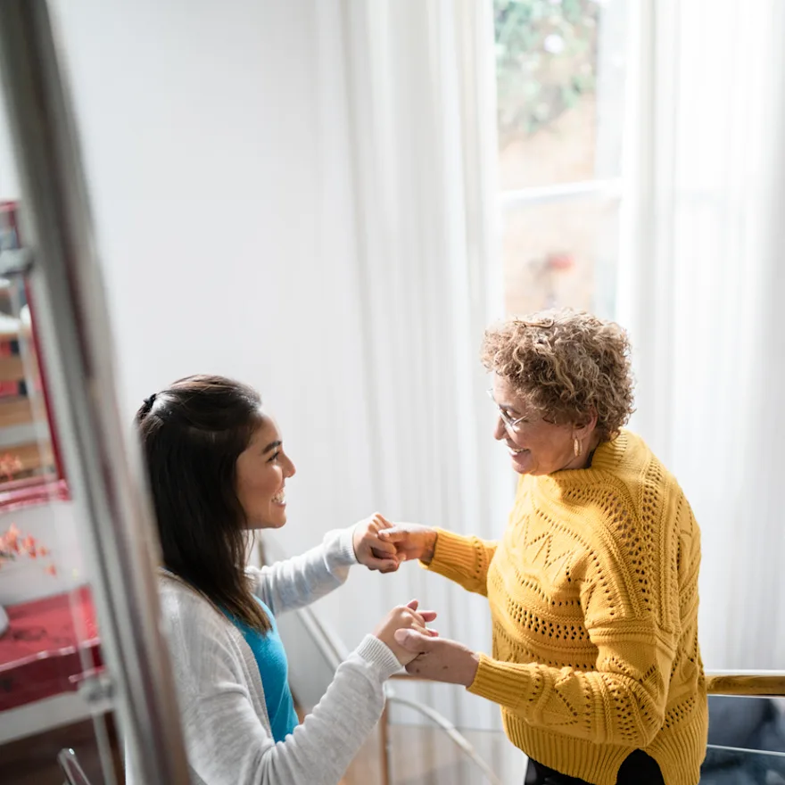 Two women practicing physical therapy exercises to prevent muscle atrohpy.