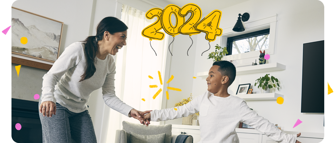 Mother and son holding hands with a 2024 balloon above their heads