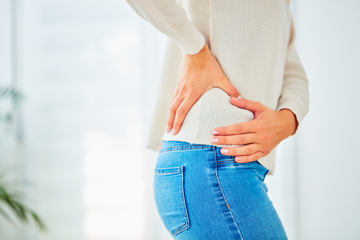 woman feeling postpartum hip pain