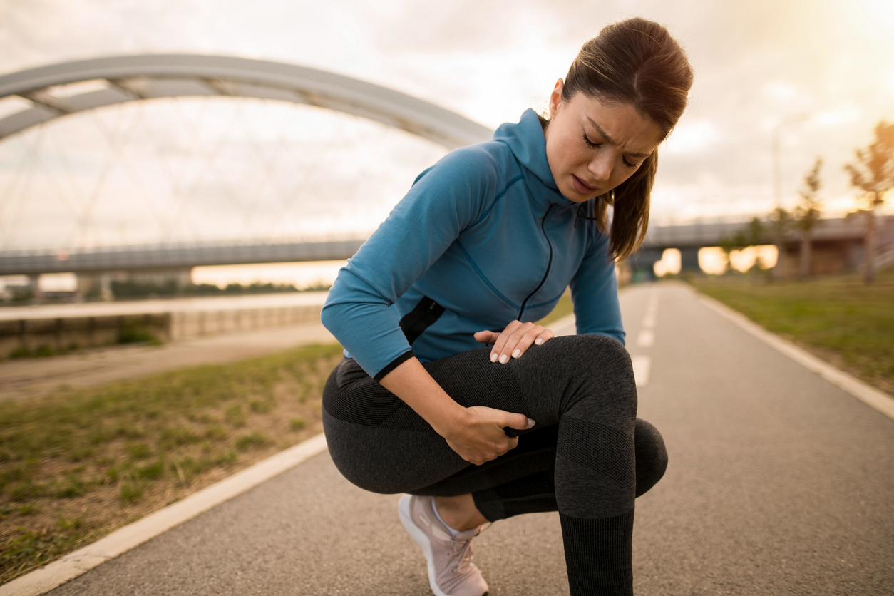 woman feeling adductor tendinopathy