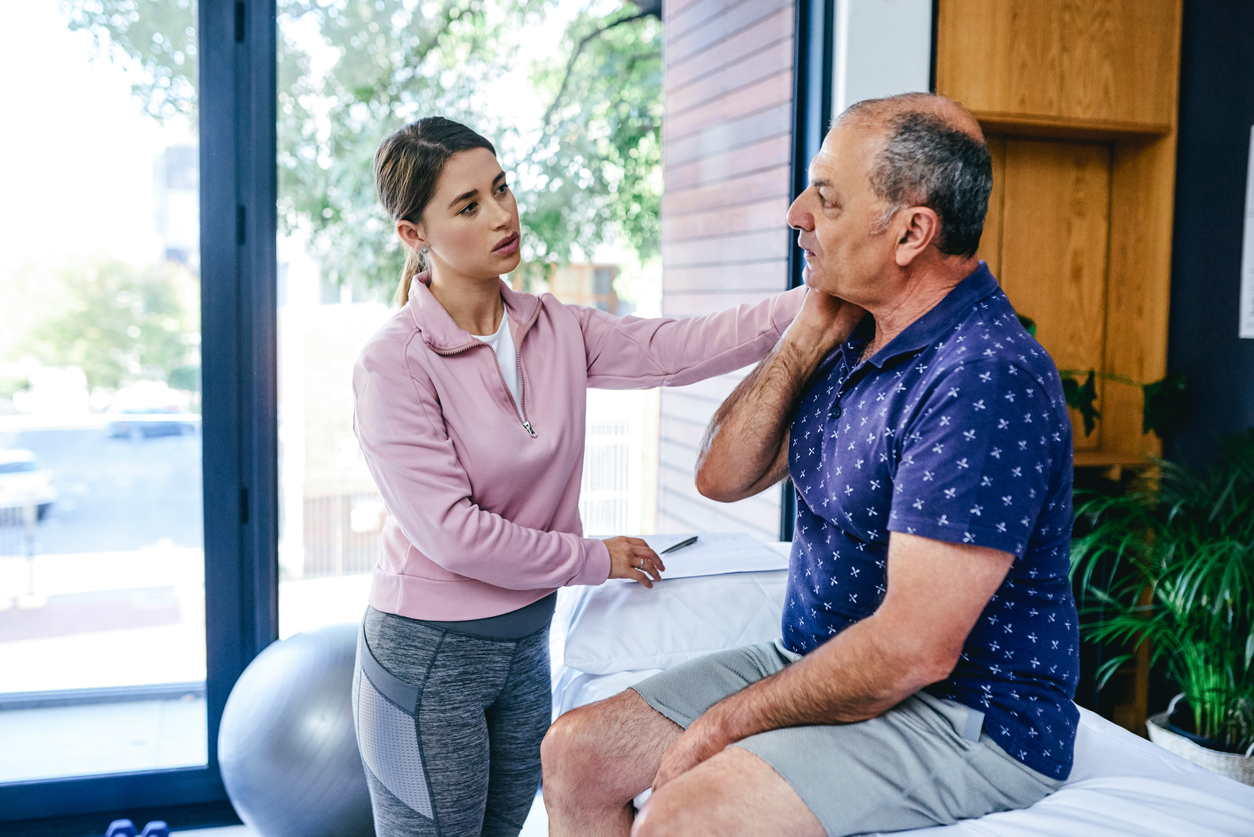 Photo of an elderly man in a physical therapy with a woman