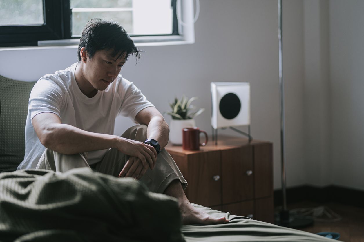 Person in white t-shirt experiencing seasonal depression.