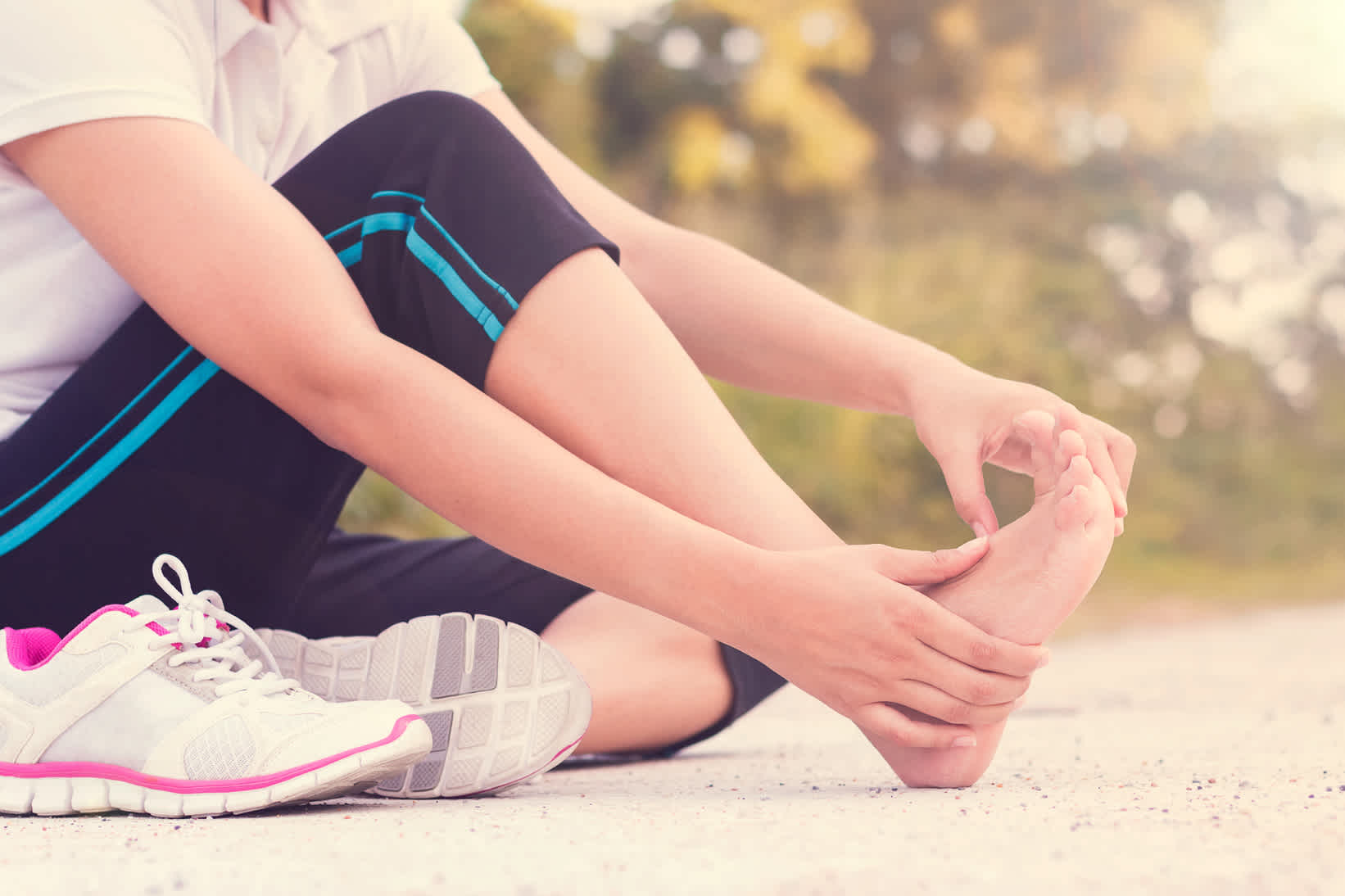 woman-laying-in-floor-streching-foot