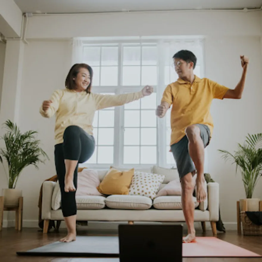 Image of two people exercising together at home