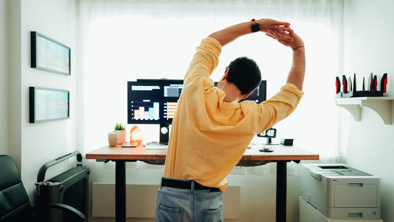 man-stretching-in-front-of-computer