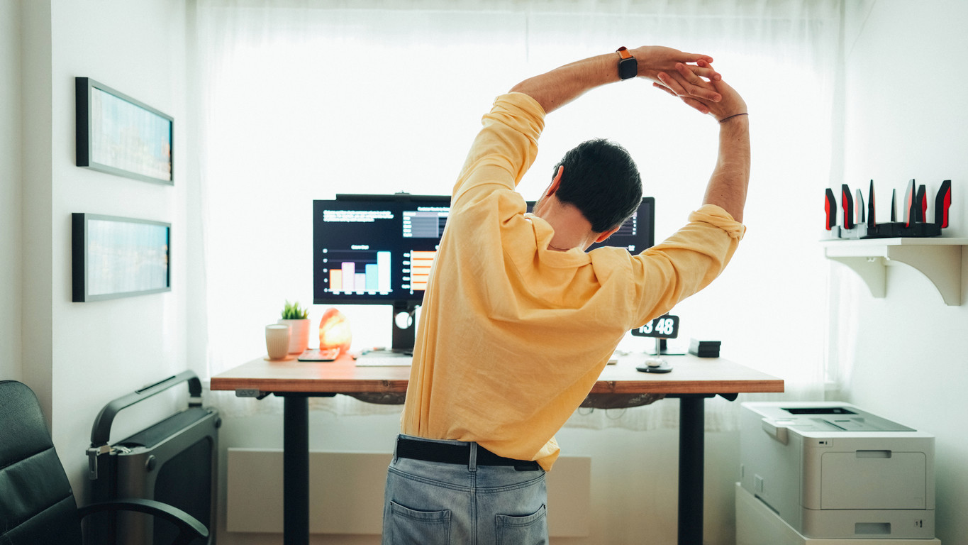 man-stretching-in-front-of-computer