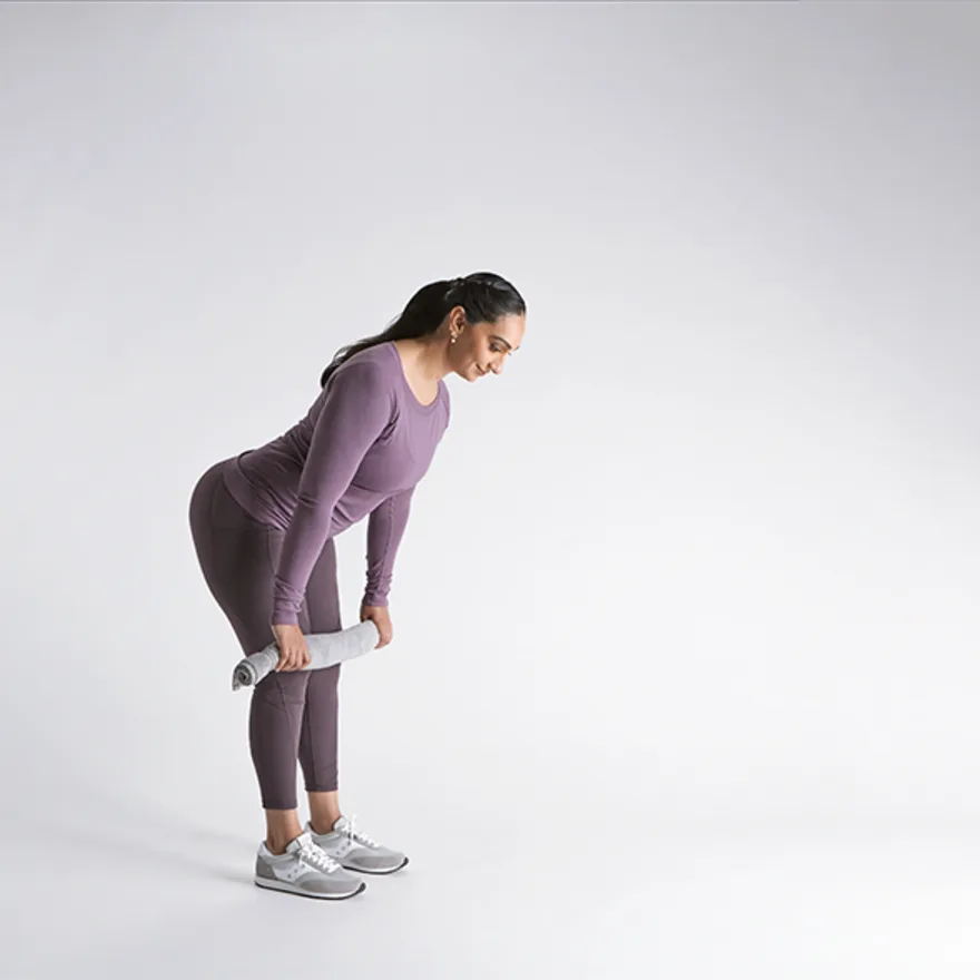 Person in purple athletic wear performing diastasis recti exercises against a white background