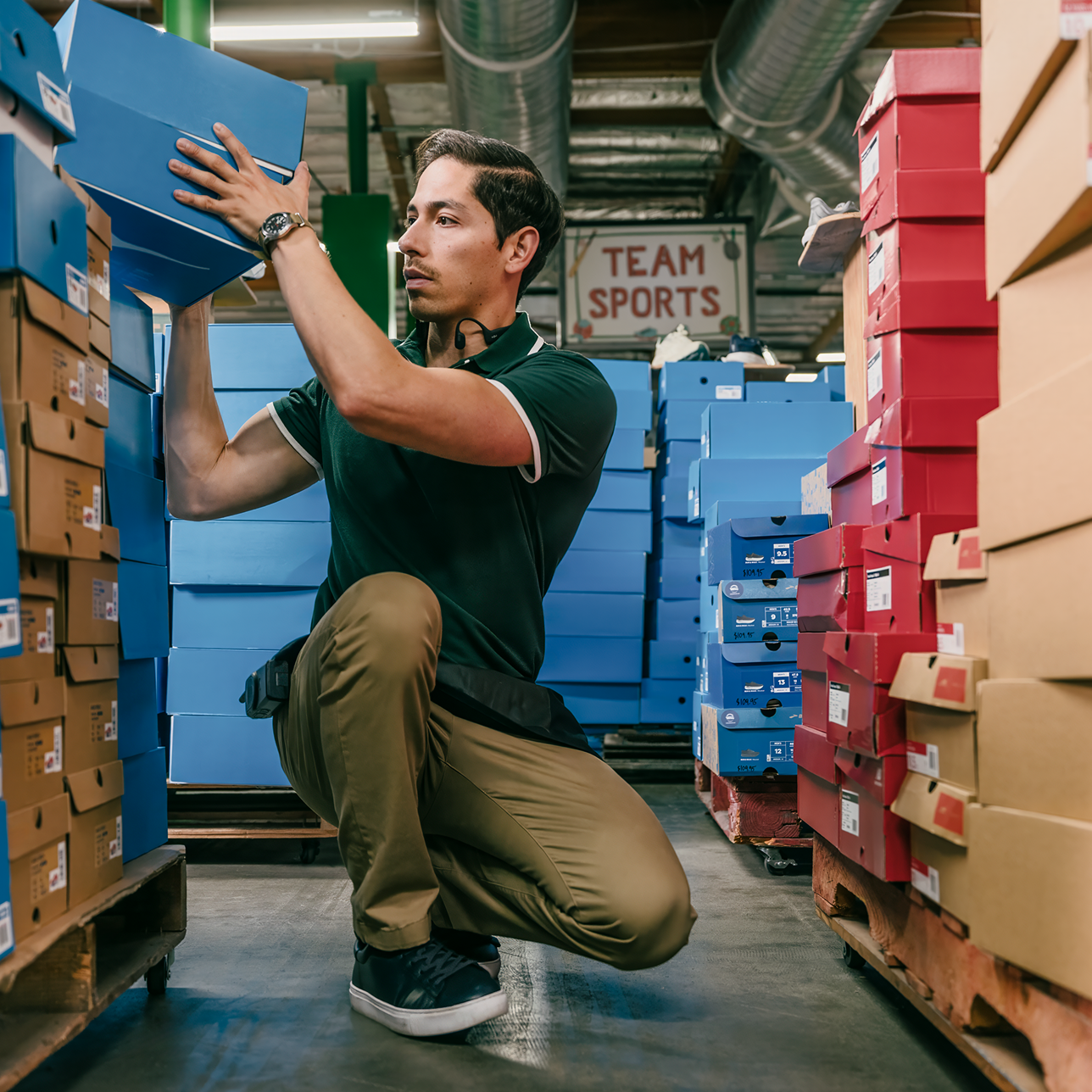 Man working in a warehouse stacking boxes