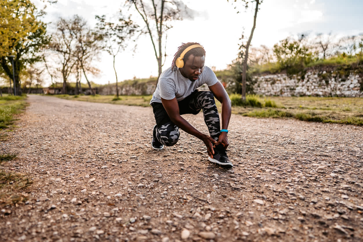 man-holding-his-ankle-in-pain-while-outdoor-run