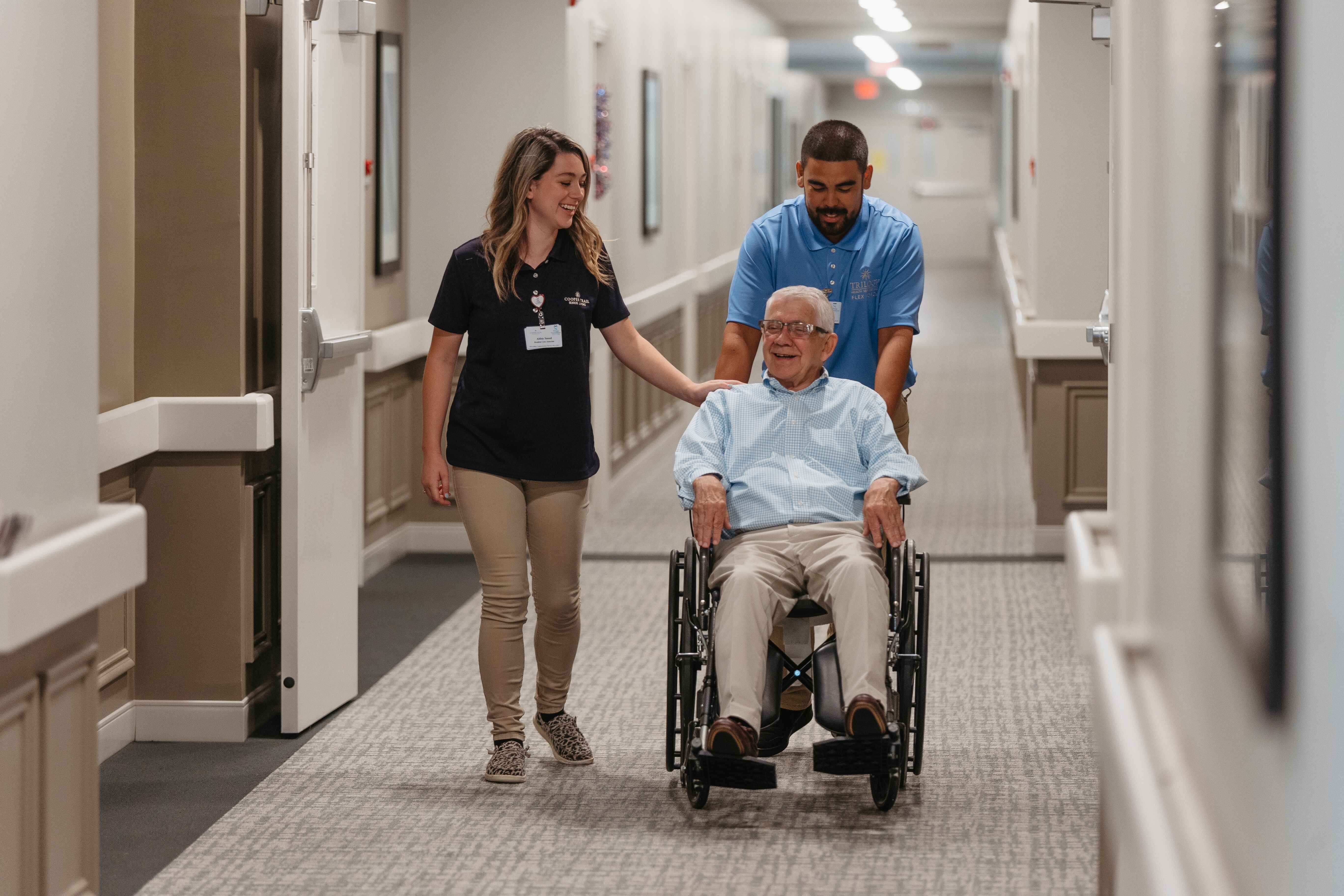 Trilogy Health Services employees with a resident