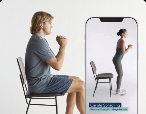 Man and woman doing exercises with chair
