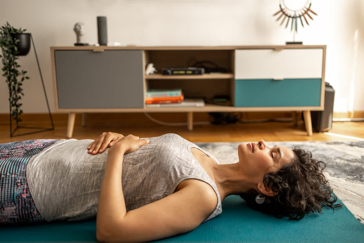 Woman doing kegel exercise on yoga mat