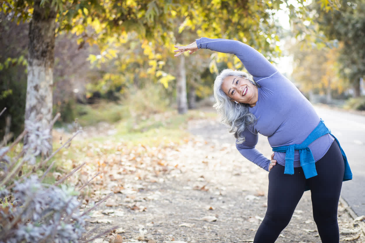 Older-woman-stretching-outdoors-in-workout-clothes