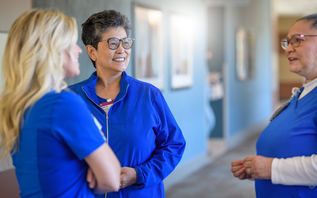Three Prisma Health employees talking in a hallway