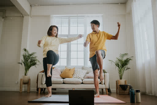 Image of two people exercising together at home