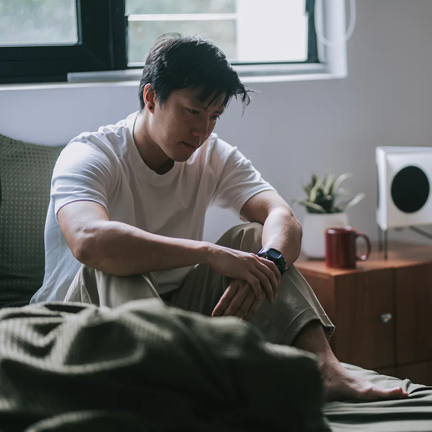 Young man in white t-shirt experiencing seasonal depression.