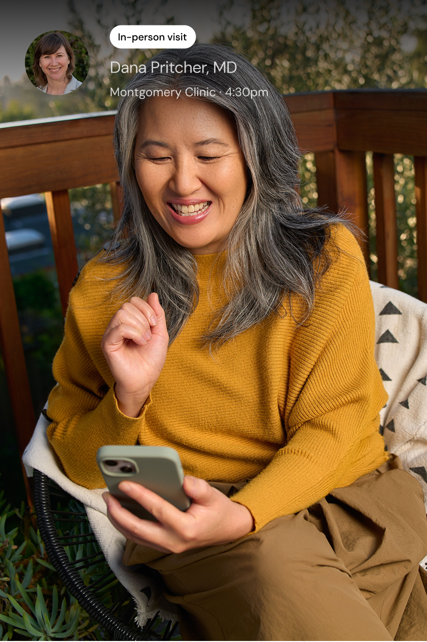 A smiling woman looks at her phone. A screen shows an in-person visit with an orthopedic MD, and a map of a downtown urban area where the office is located.