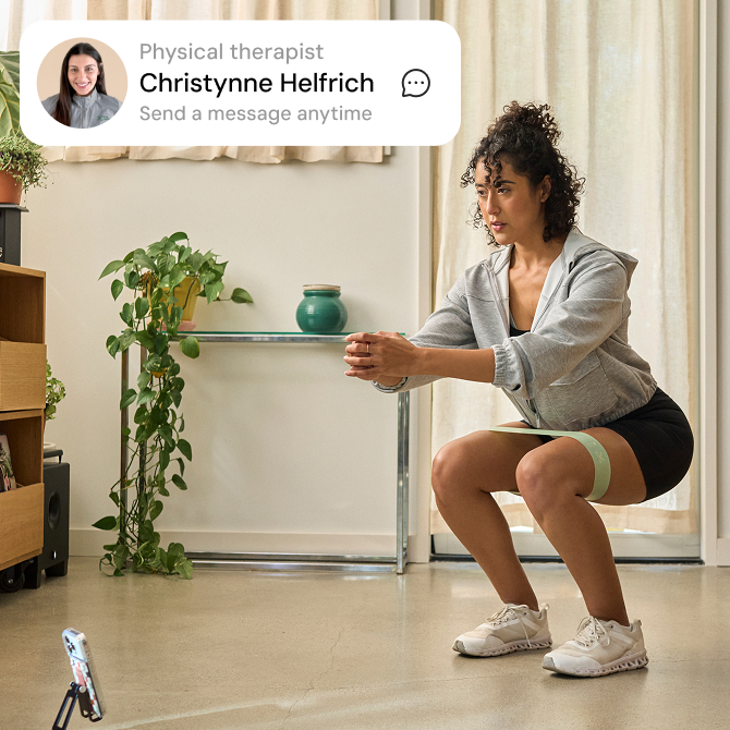 Woman doing a squat and messaging with PT