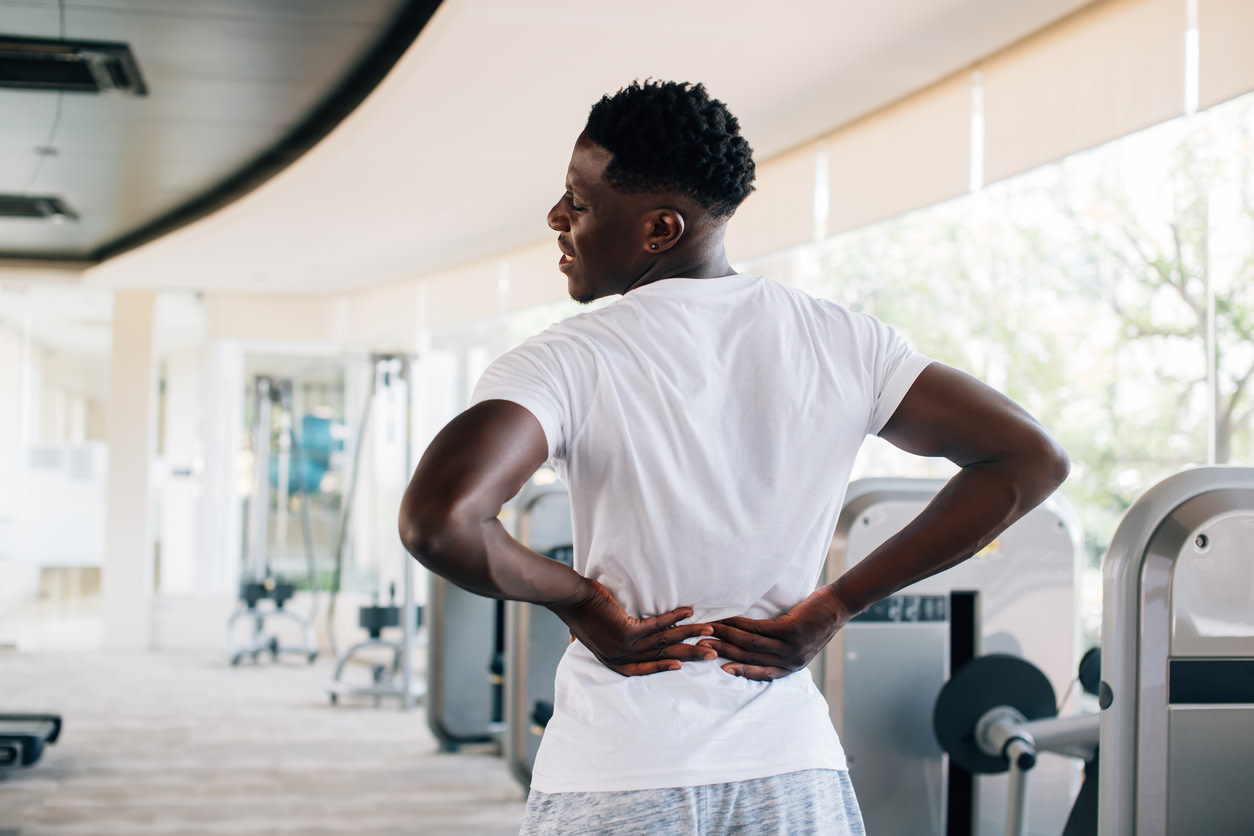 man feeling lower back pain after deadlift