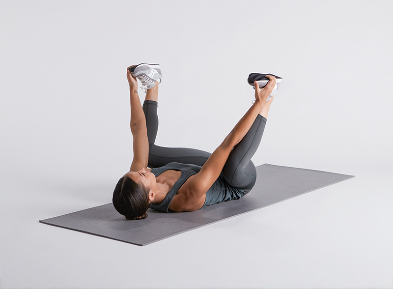 Woman doin the happy baby pose