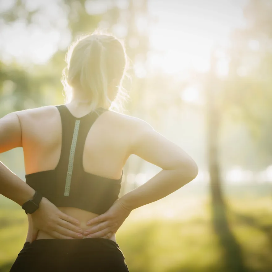 Photo of a runner woman with lower back pain