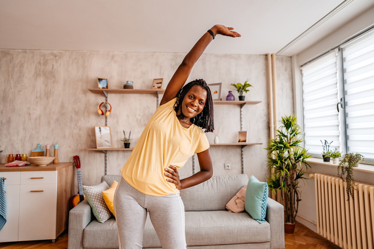 woman-stretching-in-her-living-room